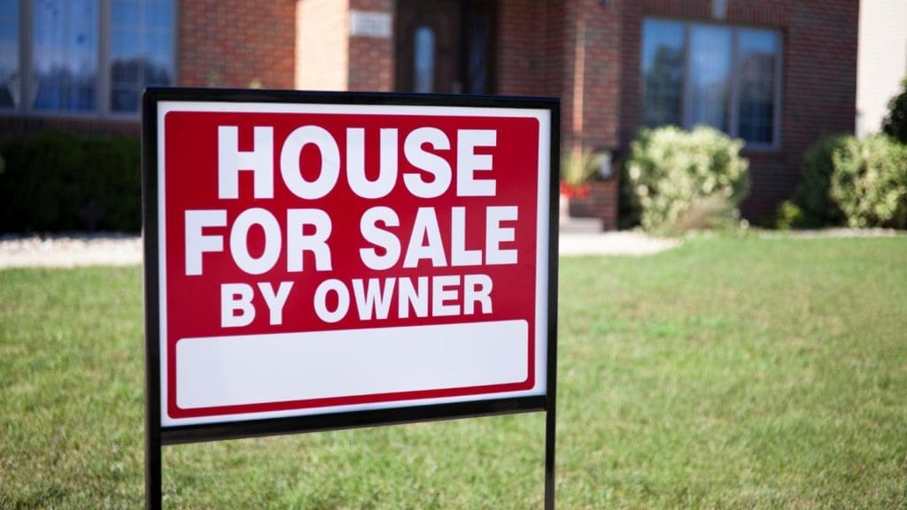 A home seller considering a "For Sale By Owner" sign