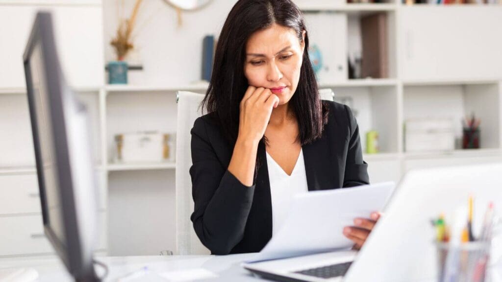 a Person Looking at a Document with a Worried Expression on Their Face | Ottawa Property Shop